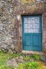 Aldeia da Cuada, Flores Island, Azores, Portugal. Blue door on a stone building. Art Print